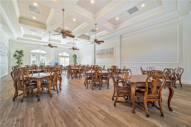 dining space with crown molding, light hardwood / wood-style flooring, coffered ceiling, and beamed ceiling