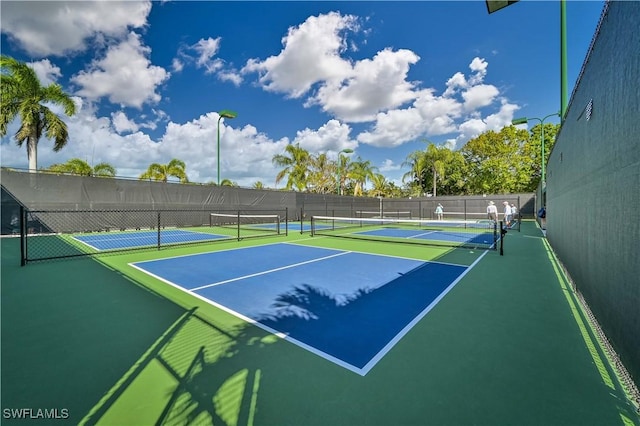 view of tennis court featuring basketball court