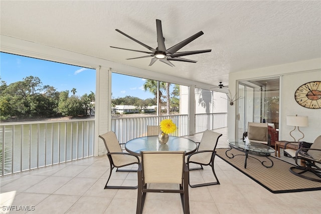 sunroom featuring ceiling fan