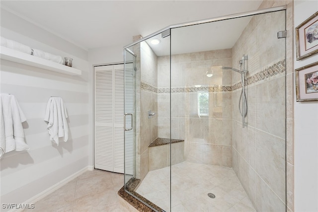 bathroom with walk in shower and tile patterned flooring