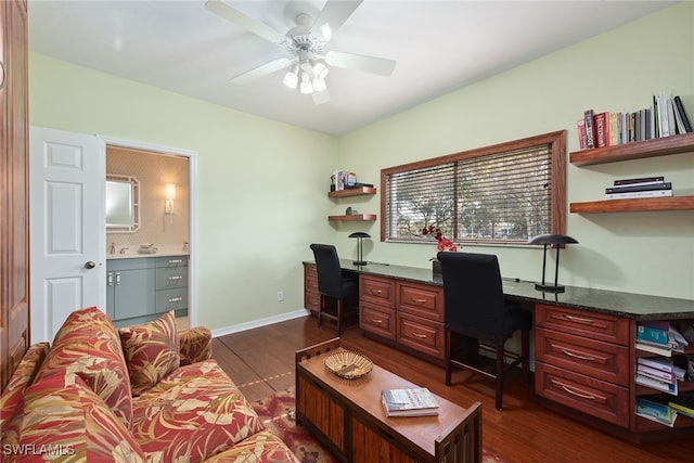 office featuring built in desk, dark hardwood / wood-style floors, sink, and ceiling fan