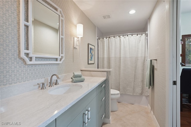 full bathroom featuring vanity, shower / bath combo with shower curtain, tile patterned flooring, and toilet