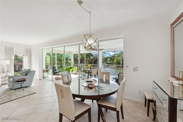 tiled dining space with a chandelier