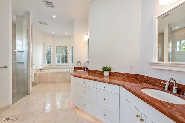 bathroom featuring vanity, tile patterned flooring, and separate shower and tub