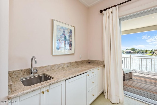 1627 Barbados Ct, Marco Island, FL 34145 - kitchen with white cabinets, light carpet, and light stone countertops