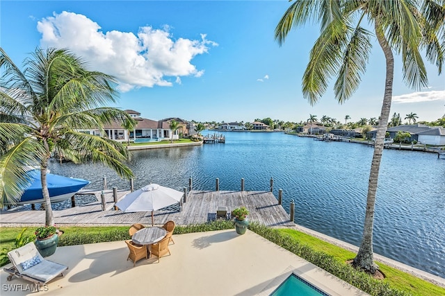 exterior space with a water view and a patio