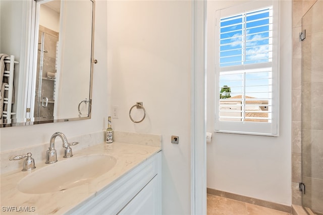 bathroom with tile patterned flooring, an enclosed shower, vanity, and radiator