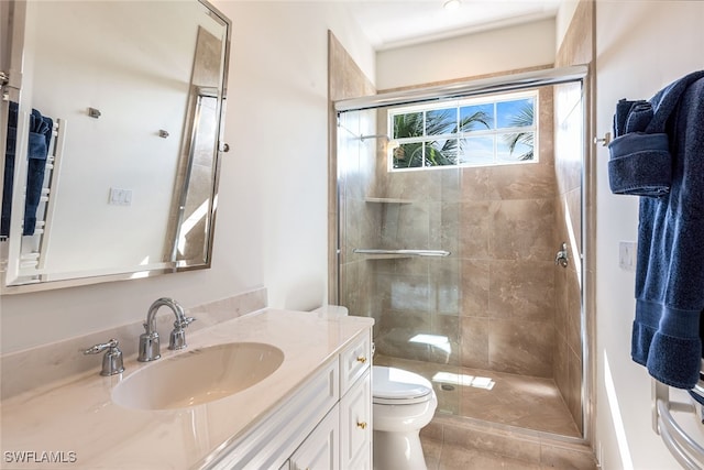 bathroom featuring vanity, tile patterned floors, toilet, and an enclosed shower