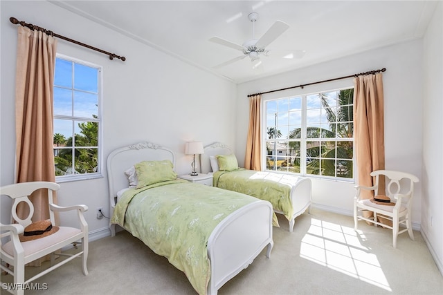 bedroom with light carpet and ceiling fan