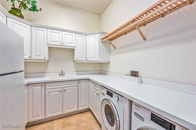 1627 Barbados Ct, Marco Island, FL 34145 - laundry room with washer and clothes dryer, light tile patterned floors, and cabinet space