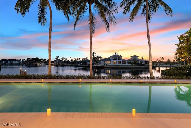 pool at dusk with a water view