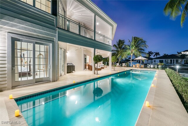 view of pool with area for grilling, french doors, and a patio area