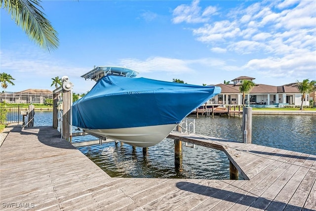 1627 Barbados Ct, Marco Island, FL 34145 - dock with boat lift, a water view, and a residential view