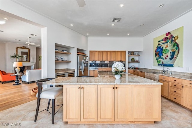 1627 Barbados Ct, Marco Island, FL 34145 - kitchen with open shelves, appliances with stainless steel finishes, ceiling fan, light stone counters, and a spacious island