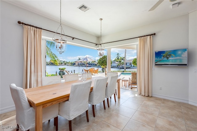 dining space with ceiling fan with notable chandelier and light tile patterned flooring