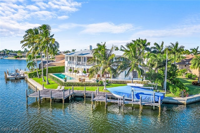 dock area featuring a yard, a pool, a water view, and a patio area