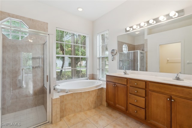 bathroom featuring plus walk in shower, vanity, and tile patterned floors