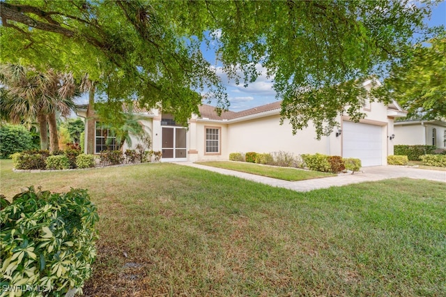 view of front of property featuring a front yard and a garage