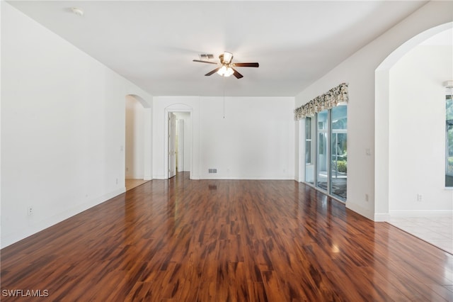 unfurnished room with ceiling fan and dark hardwood / wood-style flooring