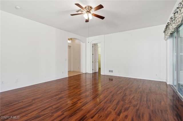 spare room featuring ceiling fan and dark wood-type flooring