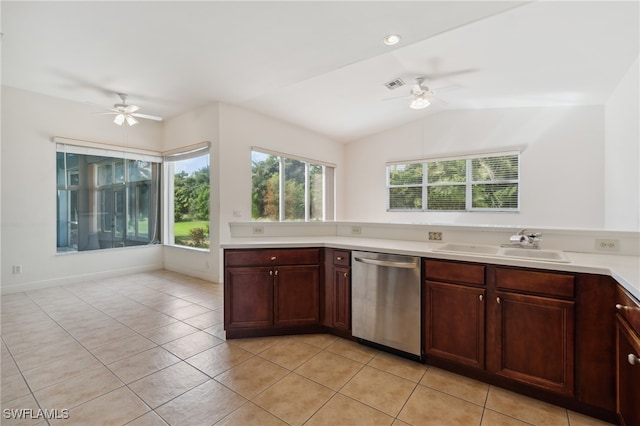 kitchen featuring light tile patterned floors, stainless steel dishwasher, ceiling fan, and lofted ceiling