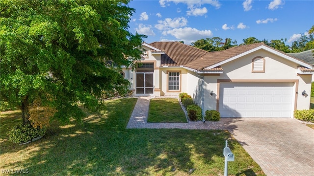 view of front of home with a garage and a front lawn