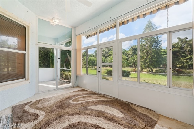 sunroom featuring ceiling fan and a healthy amount of sunlight