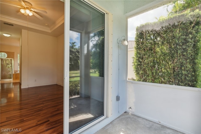 doorway to outside with hardwood / wood-style floors, ceiling fan, and ornamental molding