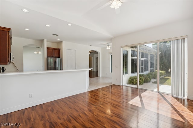 unfurnished living room with ceiling fan and wood-type flooring