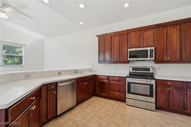 kitchen featuring appliances with stainless steel finishes, vaulted ceiling, ceiling fan, sink, and light tile patterned floors