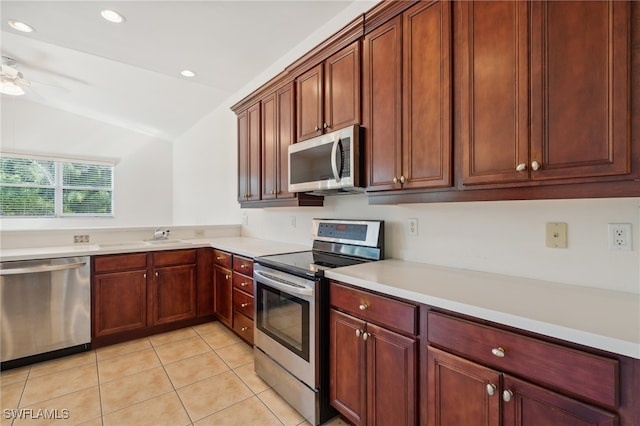 kitchen featuring stainless steel appliances, vaulted ceiling, ceiling fan, sink, and light tile patterned floors