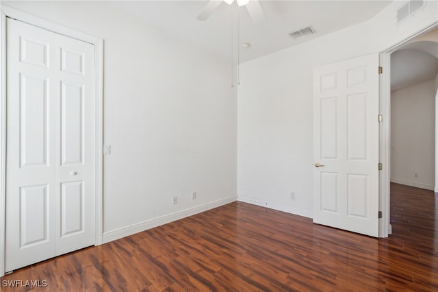 unfurnished bedroom featuring ceiling fan and dark wood-type flooring