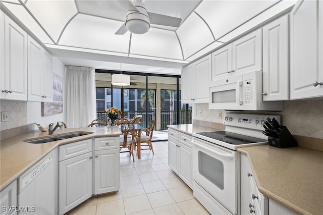 kitchen with sink, white cabinetry, tasteful backsplash, light tile patterned floors, and white appliances