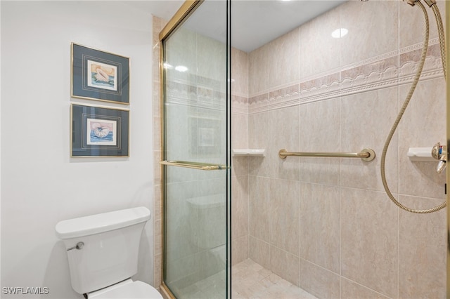 bathroom featuring an enclosed shower and toilet