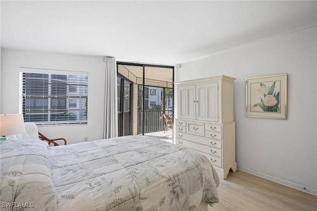 bedroom with access to outside and light hardwood / wood-style floors