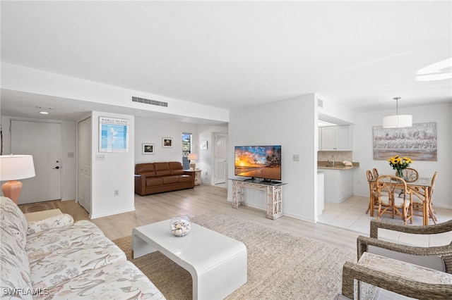 living room with light hardwood / wood-style flooring