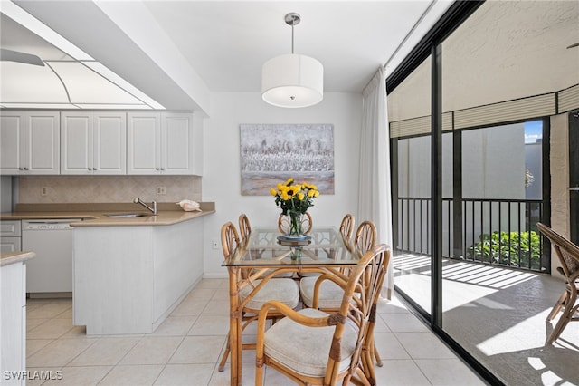 tiled dining space with sink and a wealth of natural light