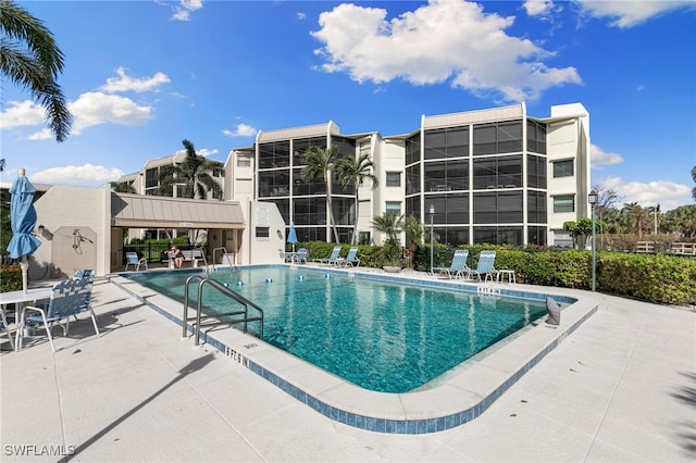 view of swimming pool with a patio area