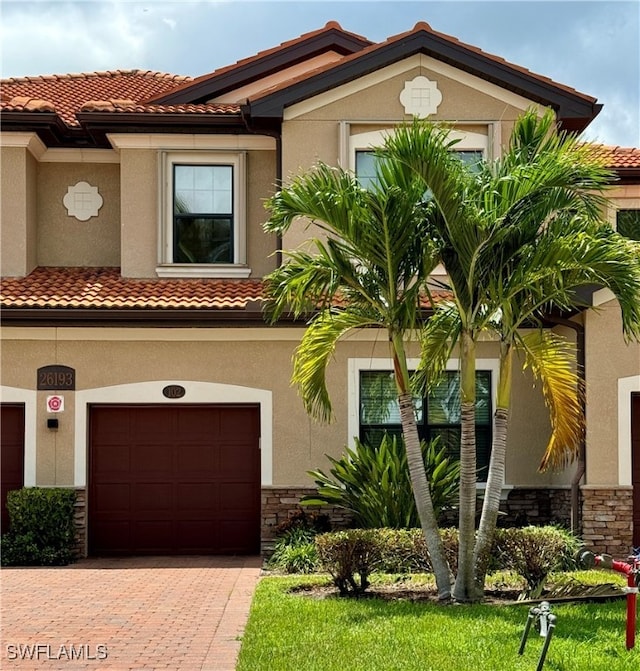 mediterranean / spanish home featuring a garage