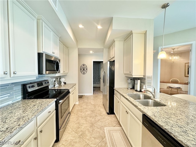 kitchen with white cabinets, sink, pendant lighting, and appliances with stainless steel finishes