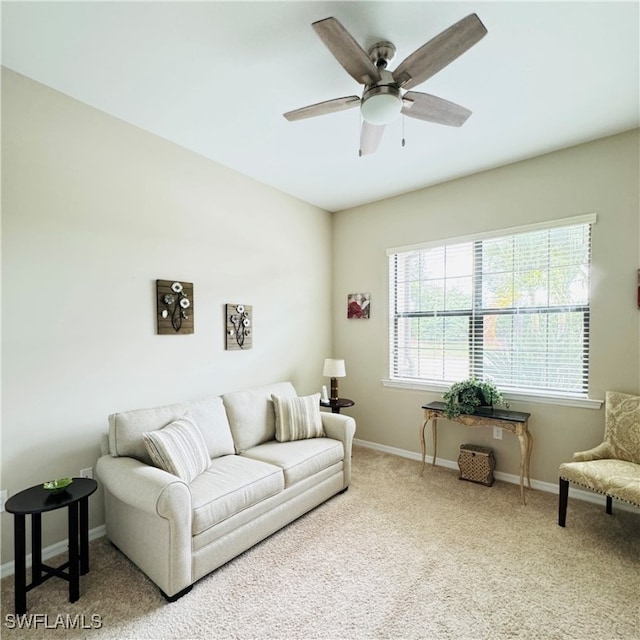 carpeted living room with ceiling fan