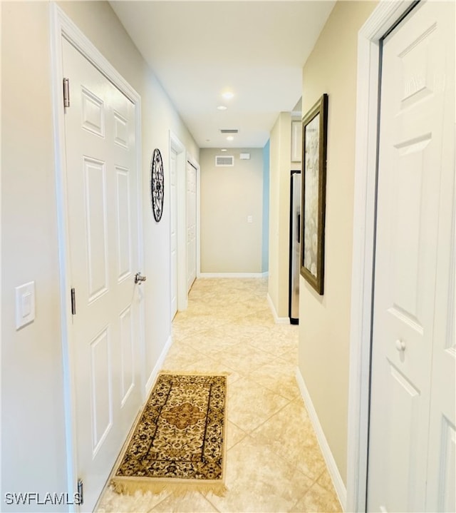 hallway featuring light tile patterned flooring