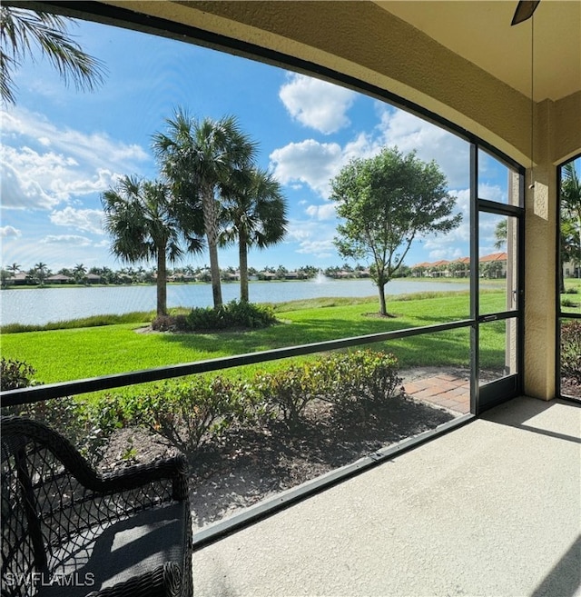 unfurnished sunroom with a water view