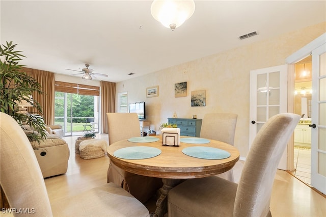 dining room featuring ceiling fan and light hardwood / wood-style flooring