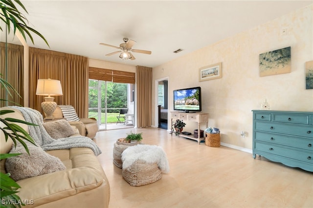 living room with light wood-type flooring and ceiling fan