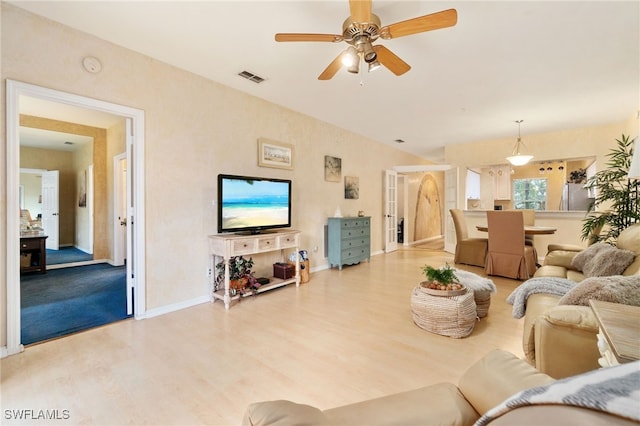 living room with hardwood / wood-style floors and ceiling fan