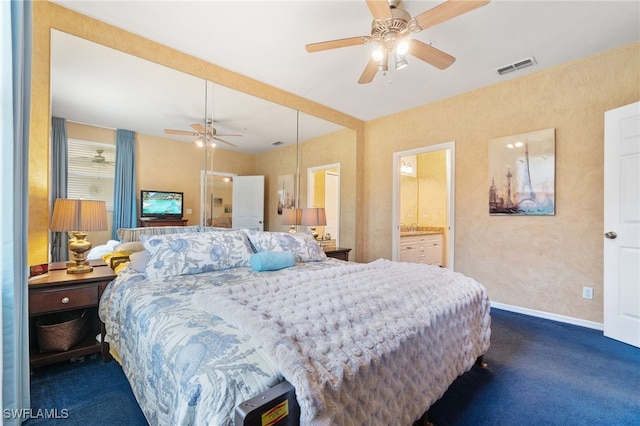 carpeted bedroom with ceiling fan and ensuite bathroom