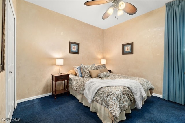 bedroom with ceiling fan and dark carpet