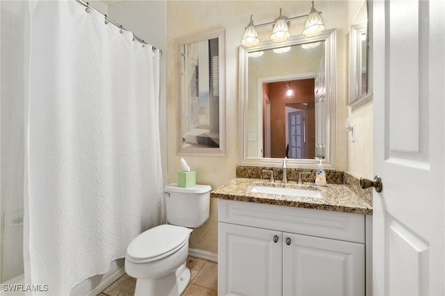 bathroom with tile patterned flooring, vanity, and toilet