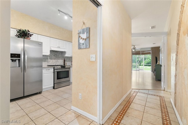 kitchen featuring appliances with stainless steel finishes, backsplash, ceiling fan, white cabinetry, and light tile patterned flooring